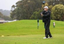 Golfers tackle rainy weather